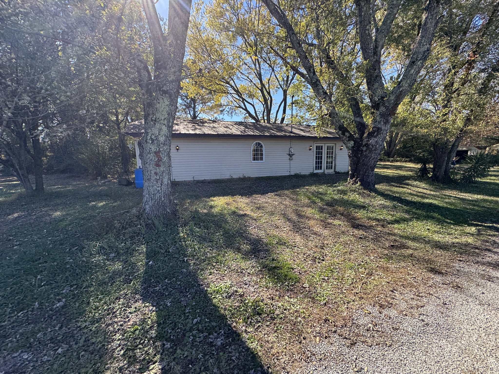 7415 Rock Creek Road Tullahoma, TN 37388 - Photo 22 of 27 a view of a house with a large tree and a yard