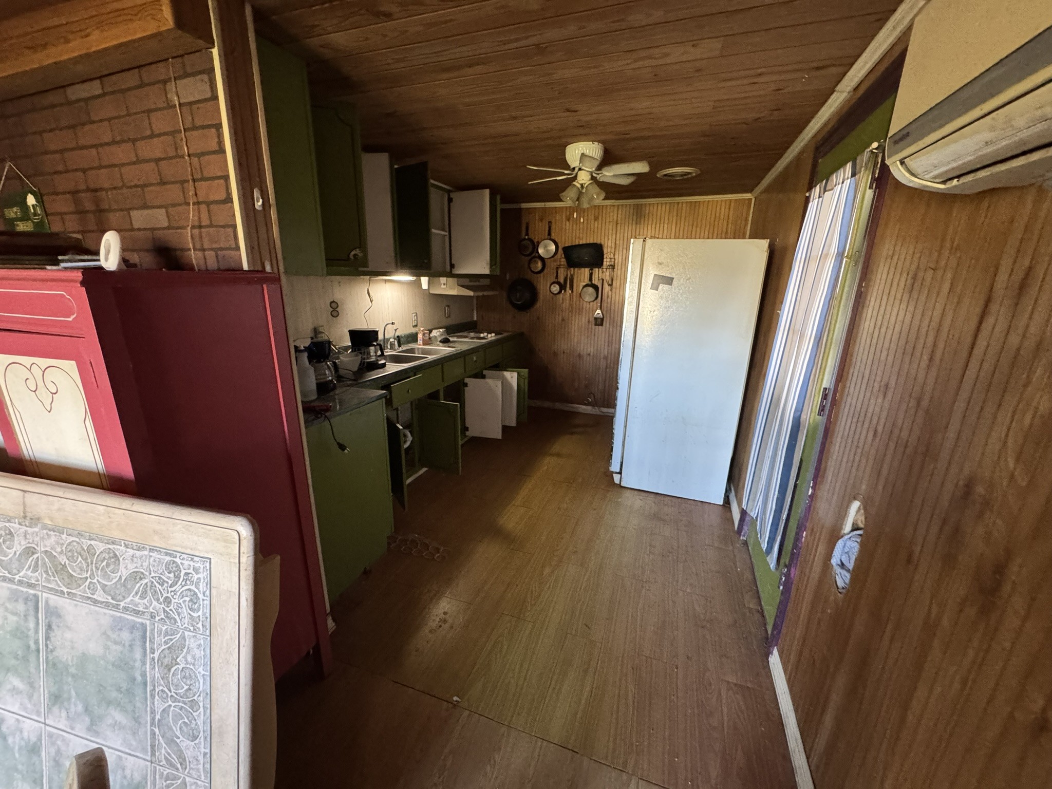 7415 Rock Creek Road Tullahoma, TN 37388 - Photo 26 of 27 a kitchen with a refrigerator a stove top oven a sink and dishwasher