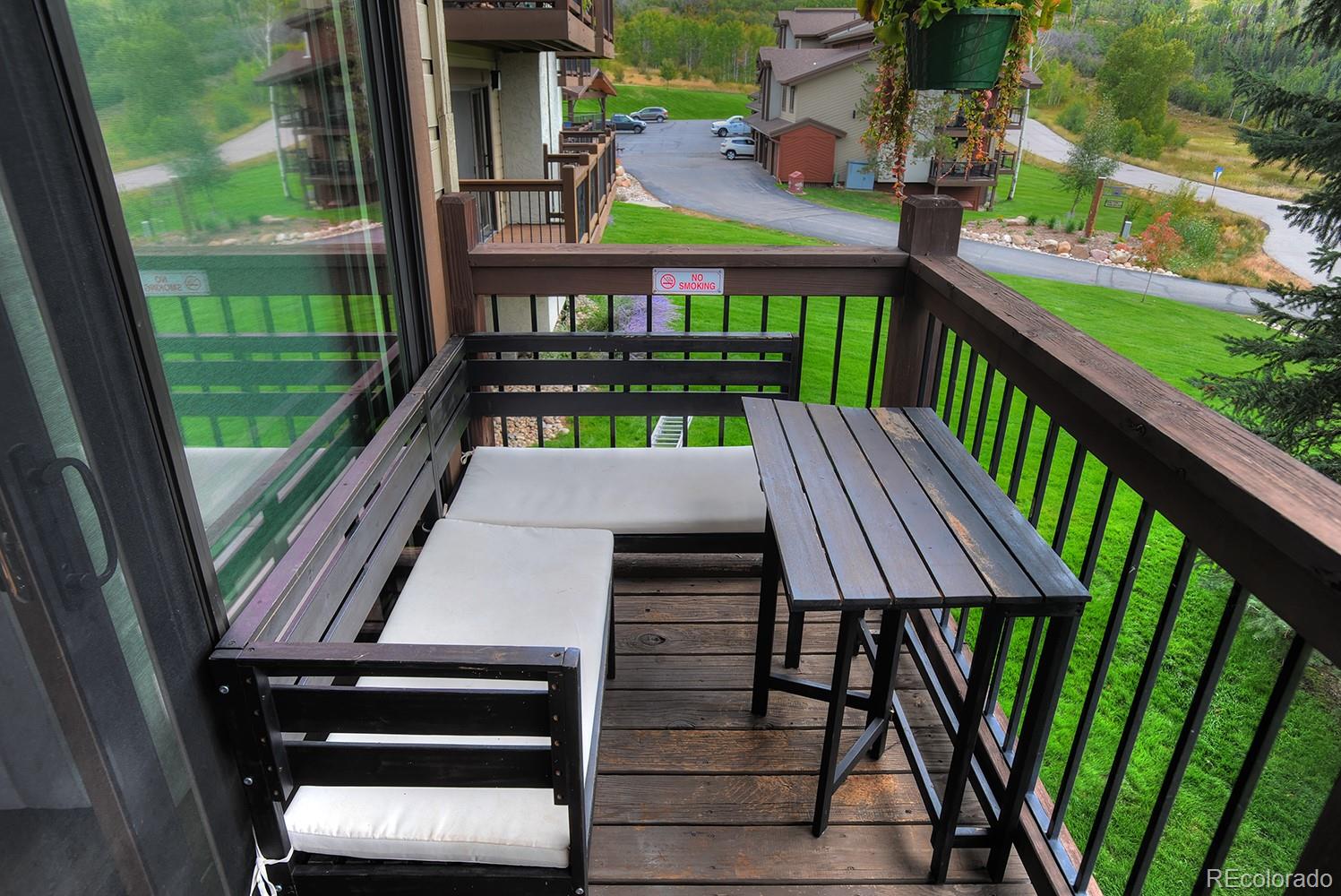 1680 Ranch Road, Unit 203 Steamboat Springs, CO 80487 - Photo 12 of 25 a view of a patio with two chairs and a table