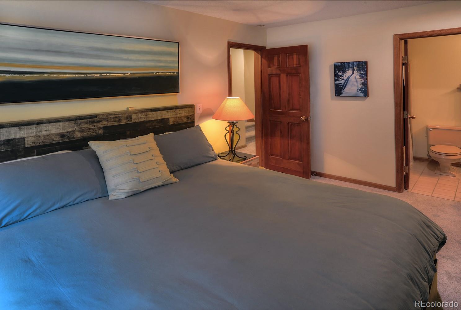 1680 Ranch Road, Unit 203 Steamboat Springs, CO 80487 - Photo 13 of 25 a bedroom with a bed and dresser