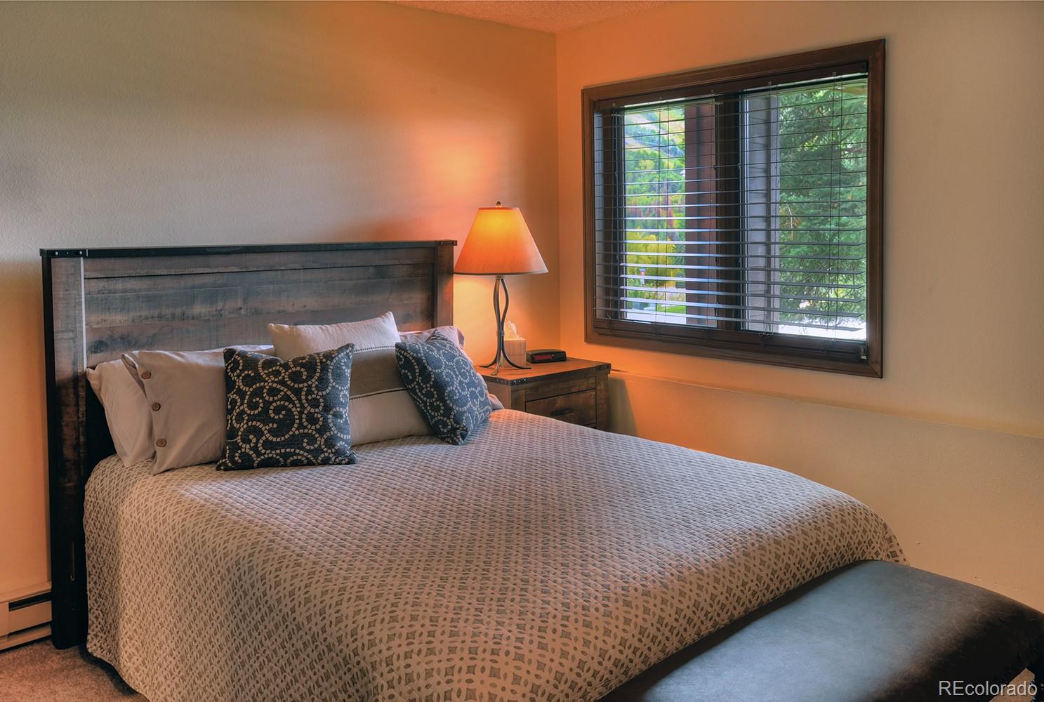 1680 Ranch Road, Unit 203 Steamboat Springs, CO 80487 - Photo 14 of 25 a bed sitting in a bedroom next to a window