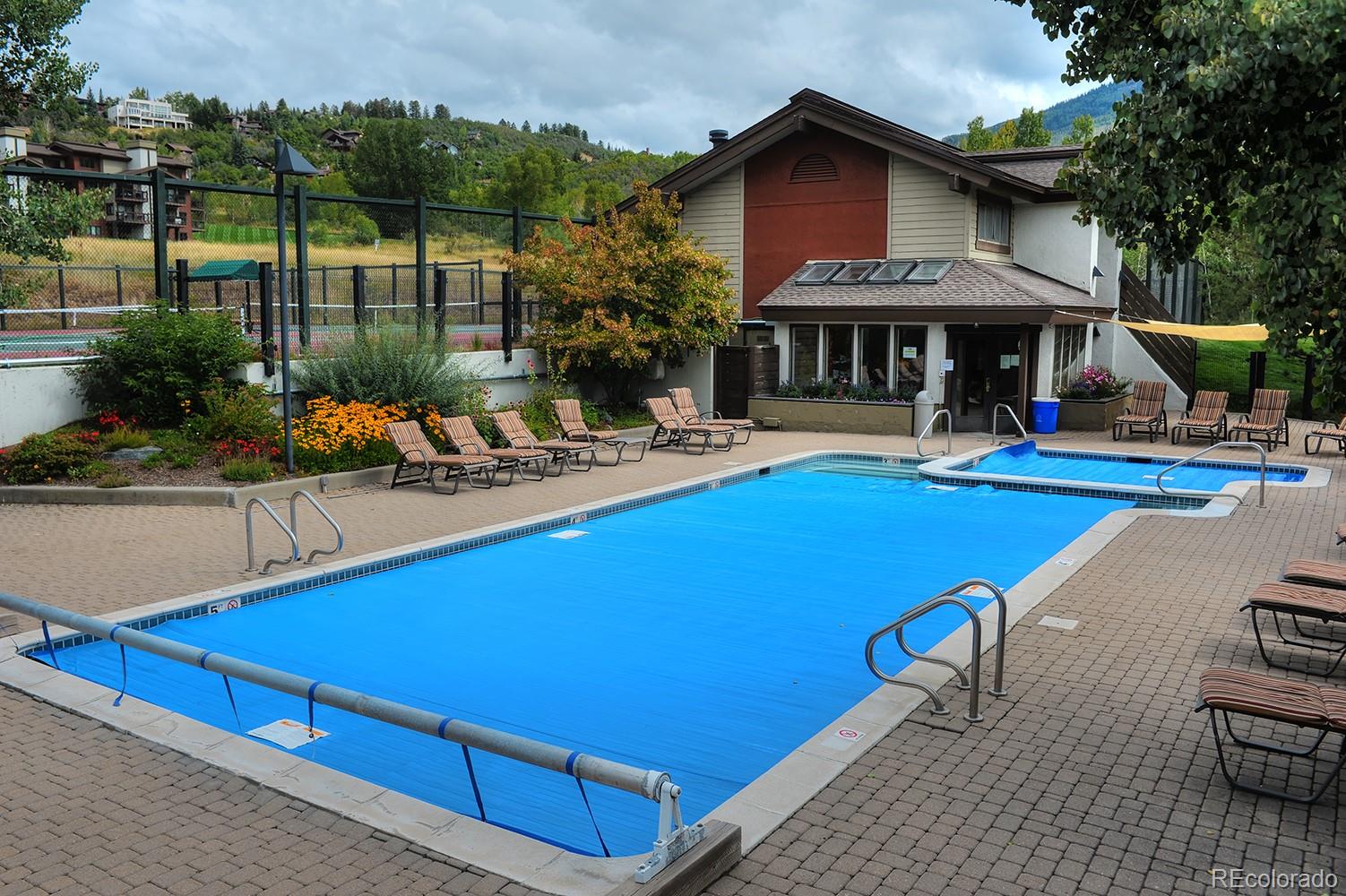 1680 Ranch Road, Unit 203 Steamboat Springs, CO 80487 - Photo 18 of 25 a view of a house with pool and chairs