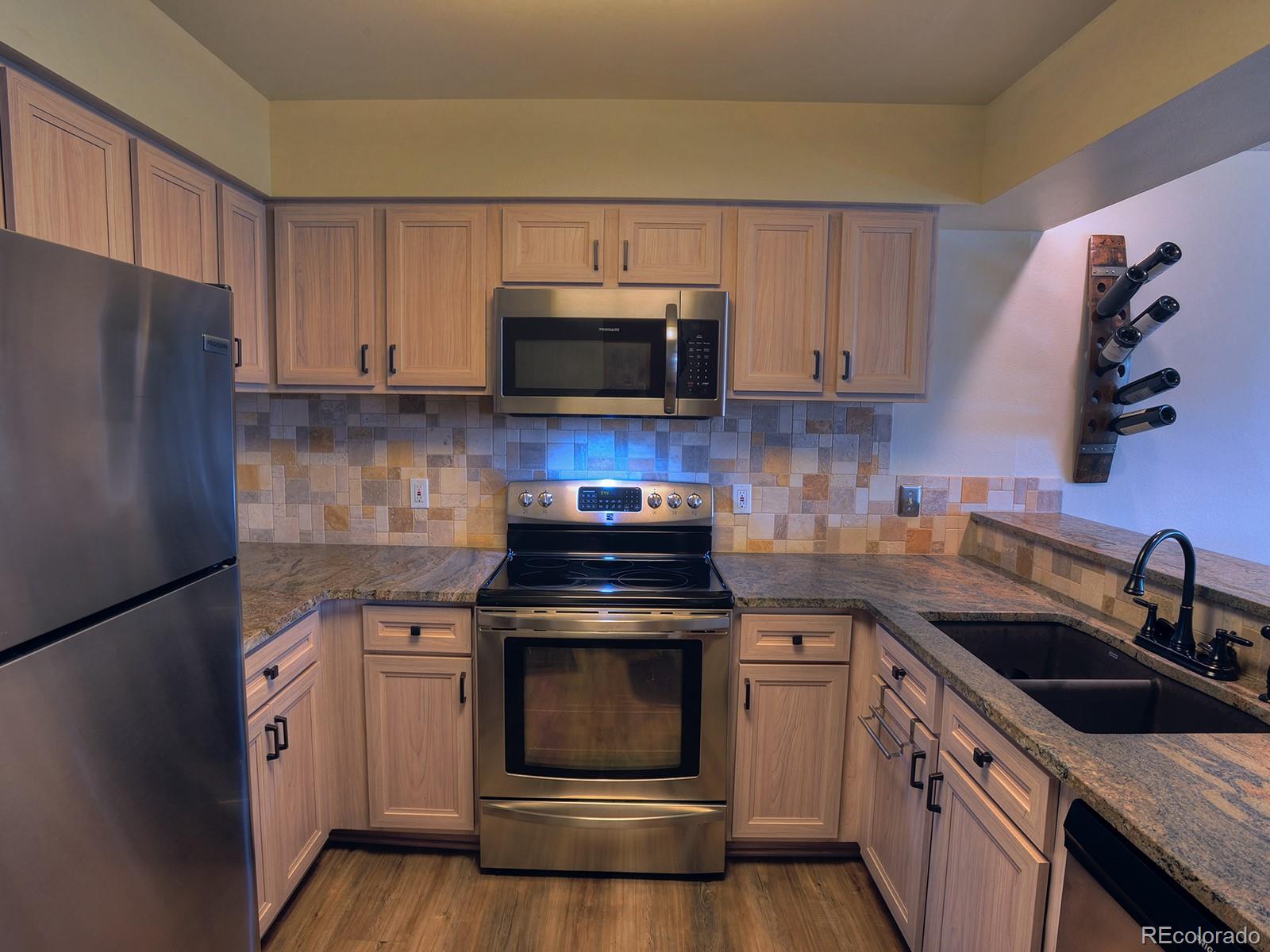 1680 Ranch Road, Unit 203 Steamboat Springs, CO 80487 - Photo 5 of 25 a kitchen with a sink stove and microwave