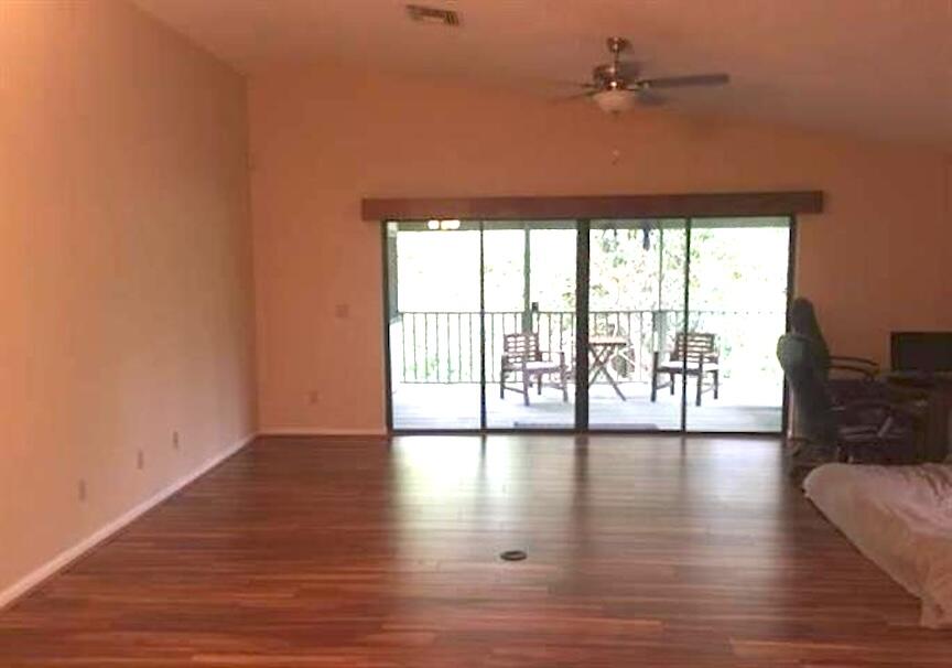 801 Tilton Road Port St. Lucie, FL 34952 - Photo 22 of 23 a view of an empty room with wooden floor and a window