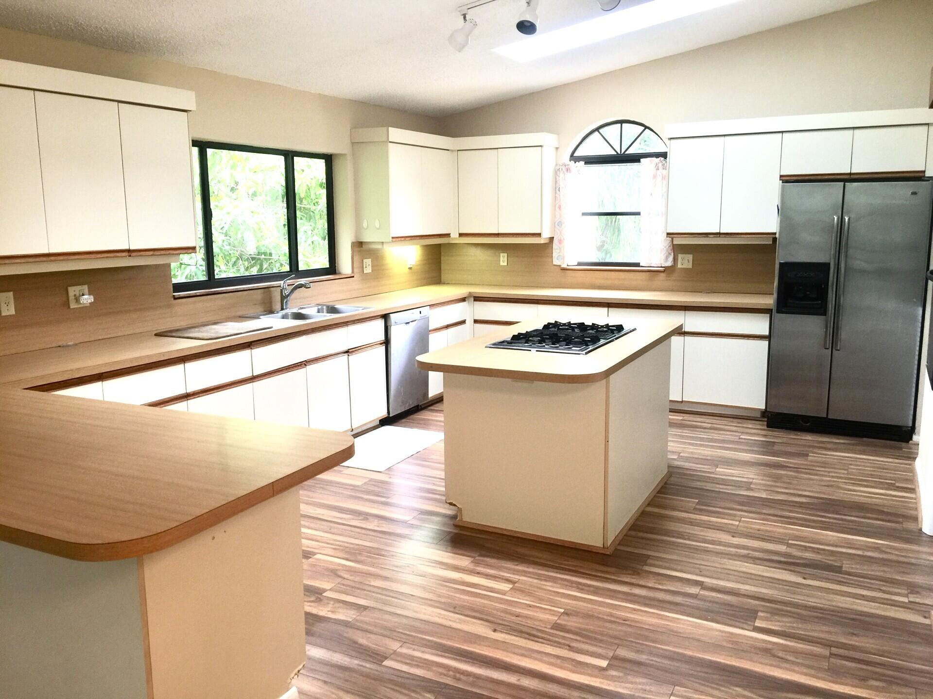 801 Tilton Road Port St. Lucie, FL 34952 - Photo 6 of 23 a kitchen with stainless steel appliances granite countertop a sink stove and refrigerator