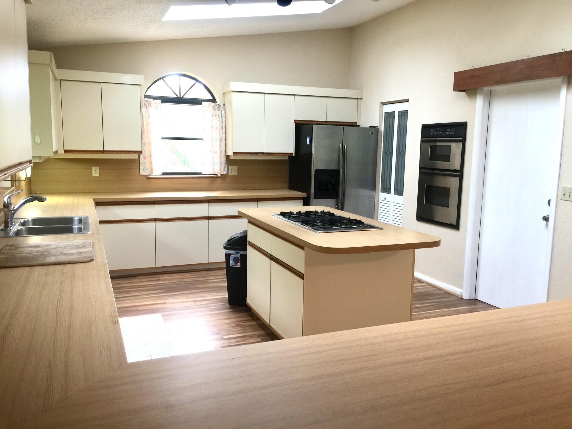 801 Tilton Road Port St. Lucie, FL 34952 - Photo 7 of 23 a kitchen with stainless steel appliances granite countertop a sink stove and refrigerator