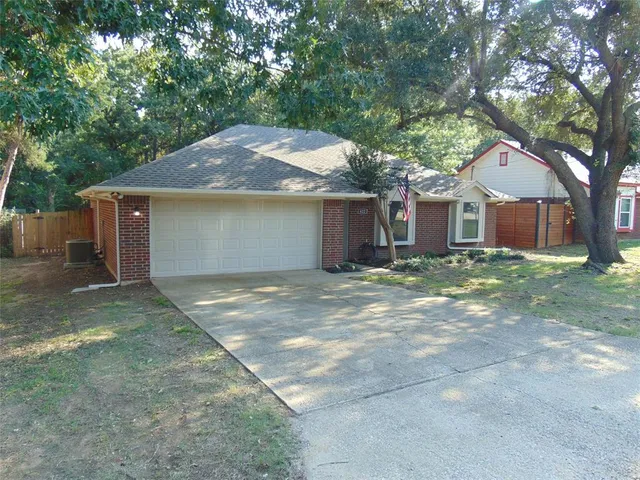 a front view of house with yard and trees