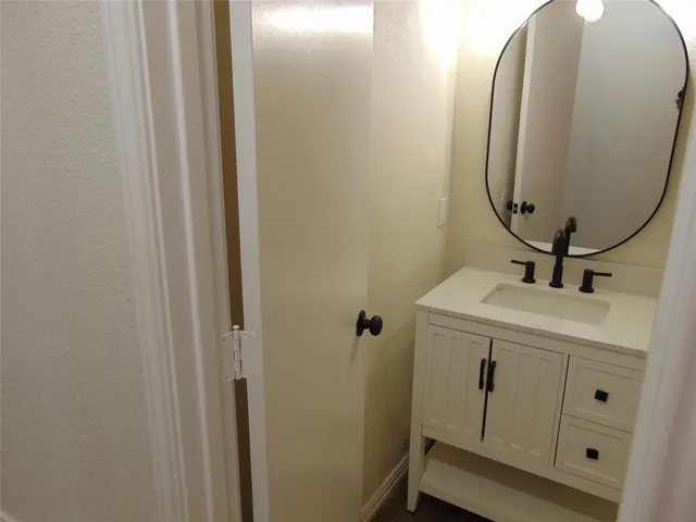 a bathroom with a sink and mirror