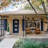 an outdoor view of a house with outdoor seating