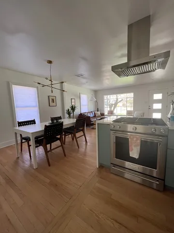 a kitchen with a potted plant and a refrigerator