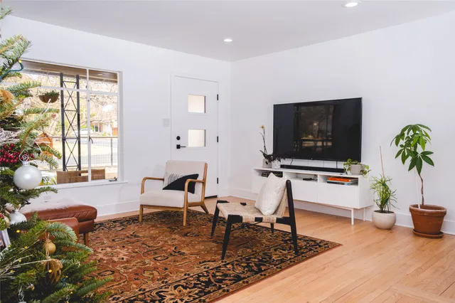 a room with a table chairs and wooden floor