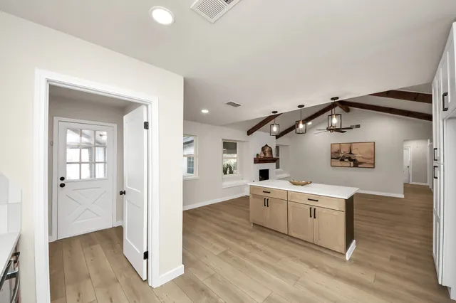 a view of a kitchen with a sink and wooden floor