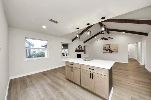 a view of a hallway with entryway and wooden floor