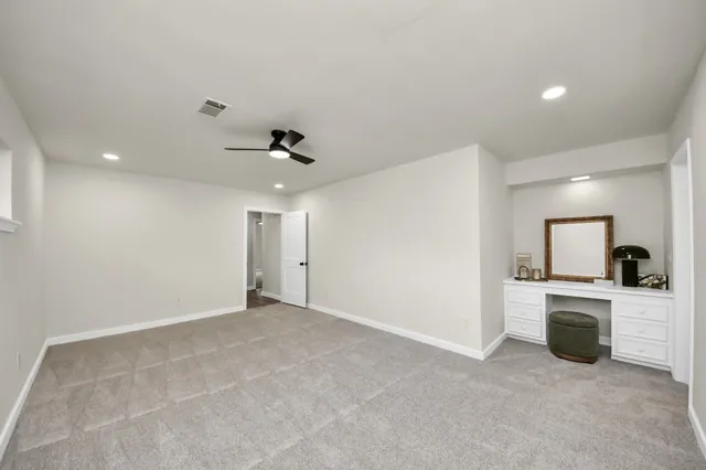 a view of a kitchen with a sink and a refrigerator