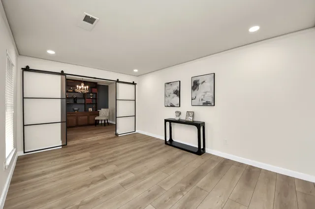 a view of a workspace with furniture and wooden floor