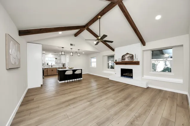 a view of open kitchen with kitchen island wooden floor and ceiling fan