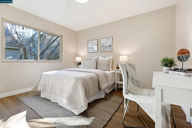 a bedroom with a bed and large windows