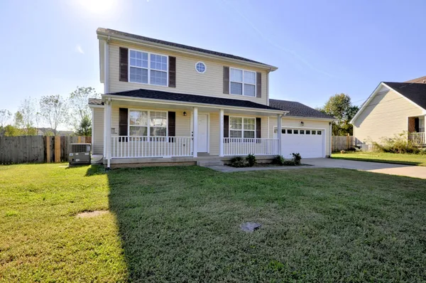 a view of house with backyard