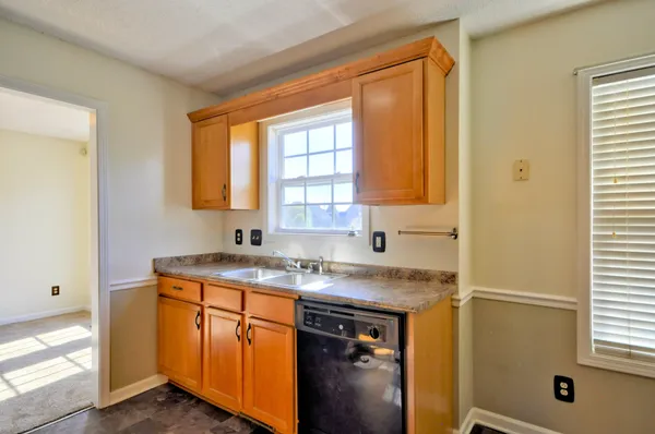 a view of a kitchen cabinets and a window