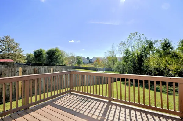 a view of balcony with wooden floor and fence