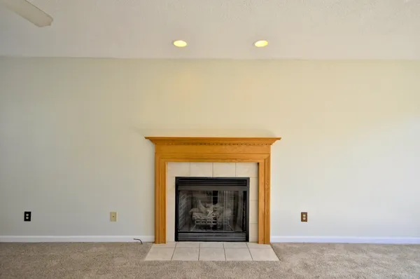a view of an empty room with a fireplace