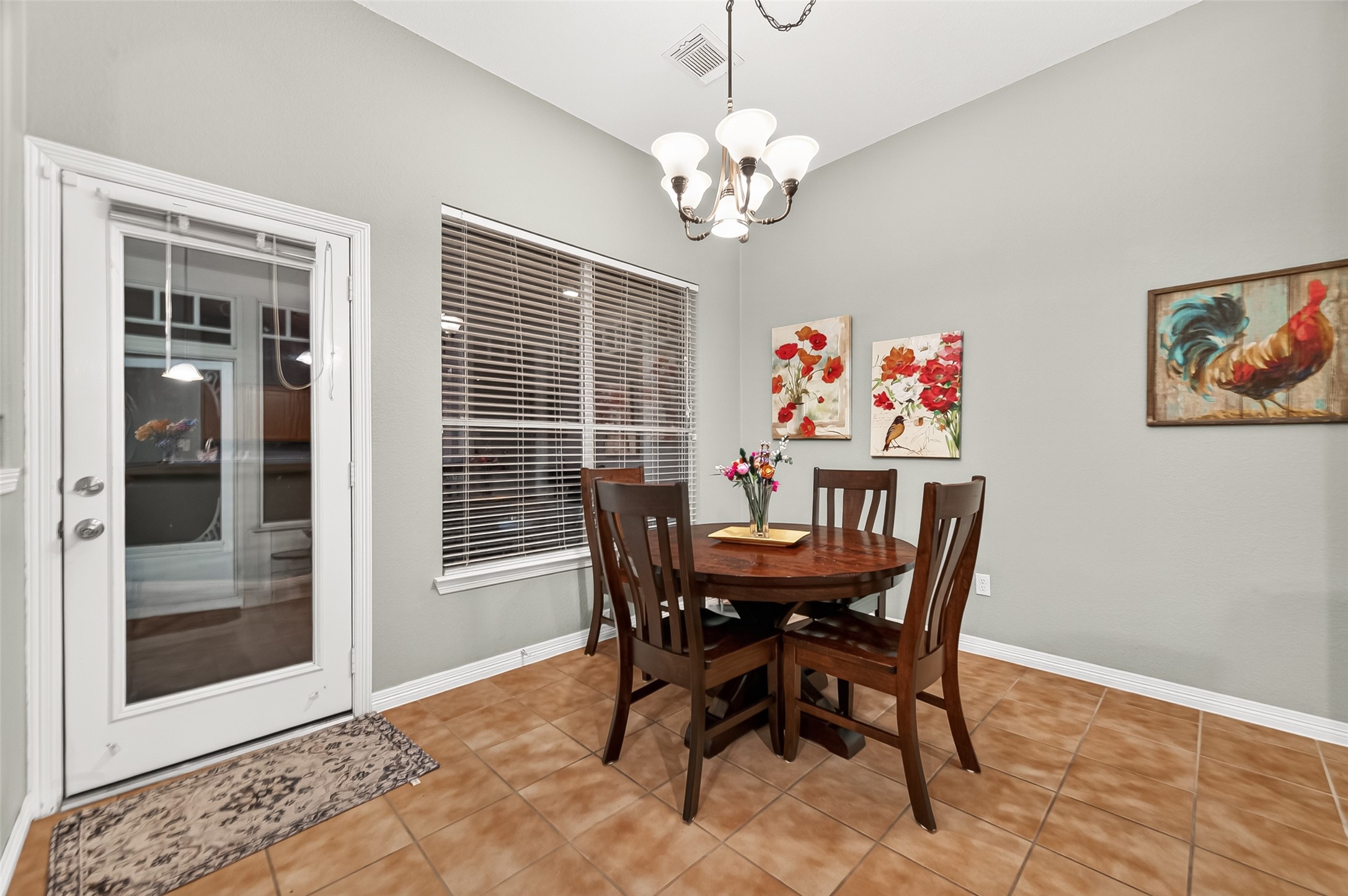 12455 West Summerlin Conroe, TX 77302 - Photo 15 of 31 a dining room with furniture a chandelier and wooden floor