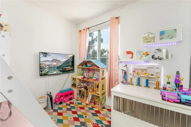 a bedroom with baby bed baby crib and book shelf