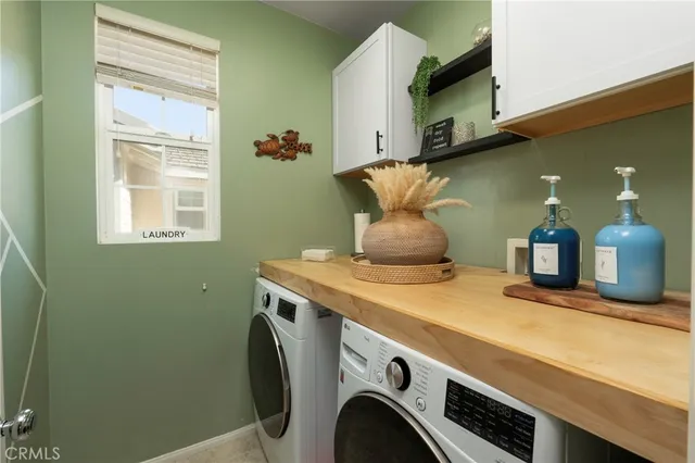 a room with a washing machine and a mirror