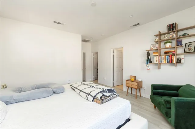 a bedroom with a bed table and chair