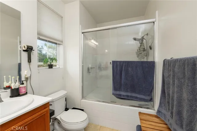 a bathroom with a toilet a sink and shower