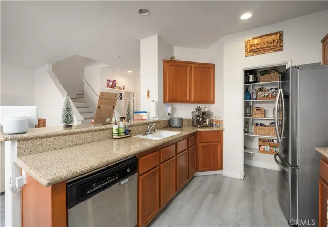 a kitchen with stainless steel appliances granite countertop a sink and cabinets