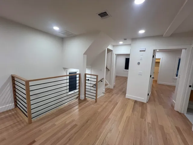 a view of a hallway with wooden floor