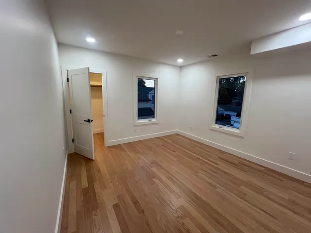 wooden floor in an empty room with a window
