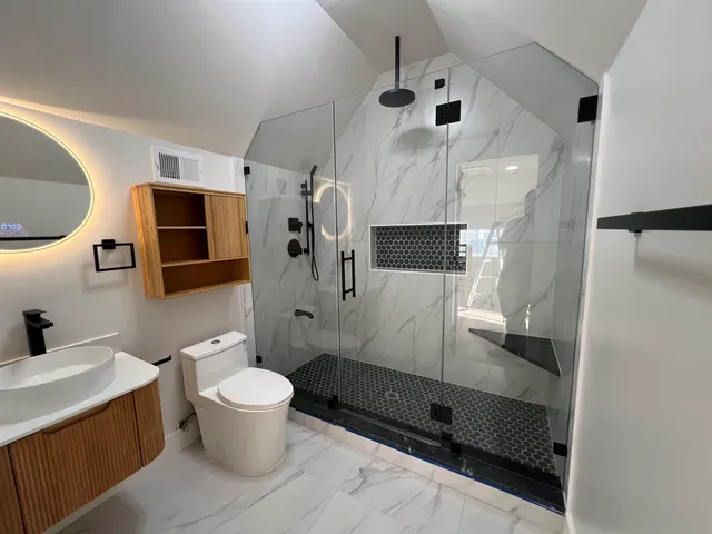 a bathroom with a sink toilet and shower