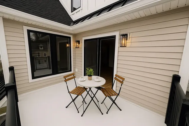 a view of a chair and table in front of the house