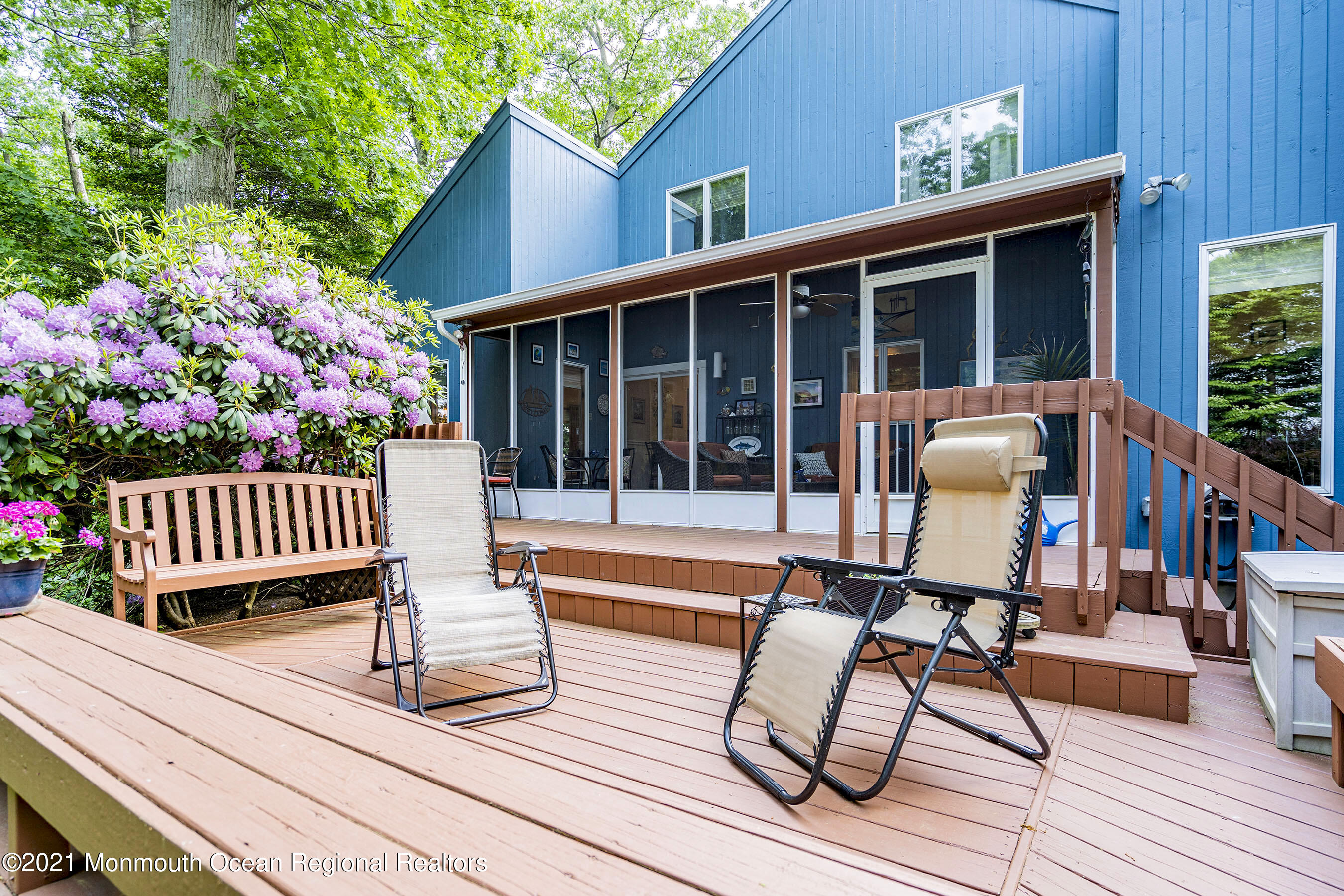 a view of a deck with wooden floor and outdoor seating
