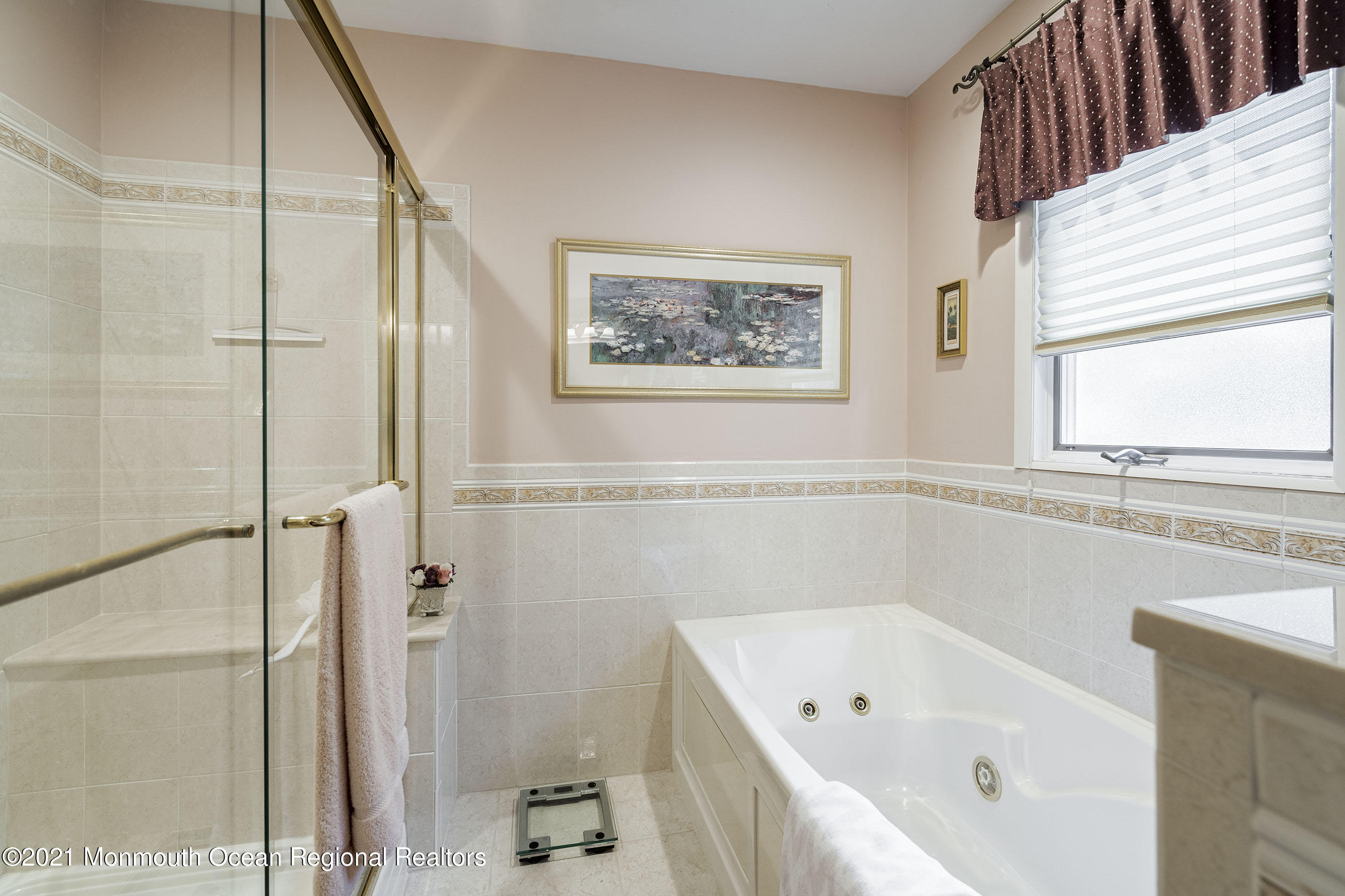 617 Turkey Point Road Brick, NJ 08724 - Photo 33 of 43 a bathroom with a tub a window and a shower