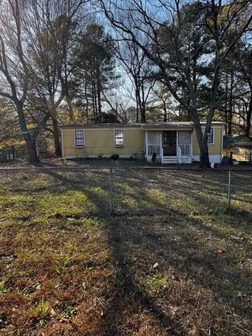 a view of a backyard with large trees