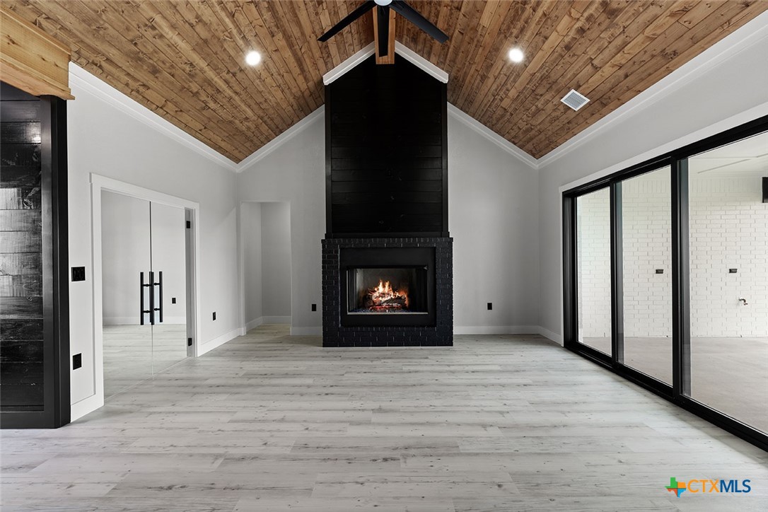 1220 Hadley Lane Copperas Cove, TX 76522 - Photo 2 of 17 a view of an empty room with wooden floor and a fireplace