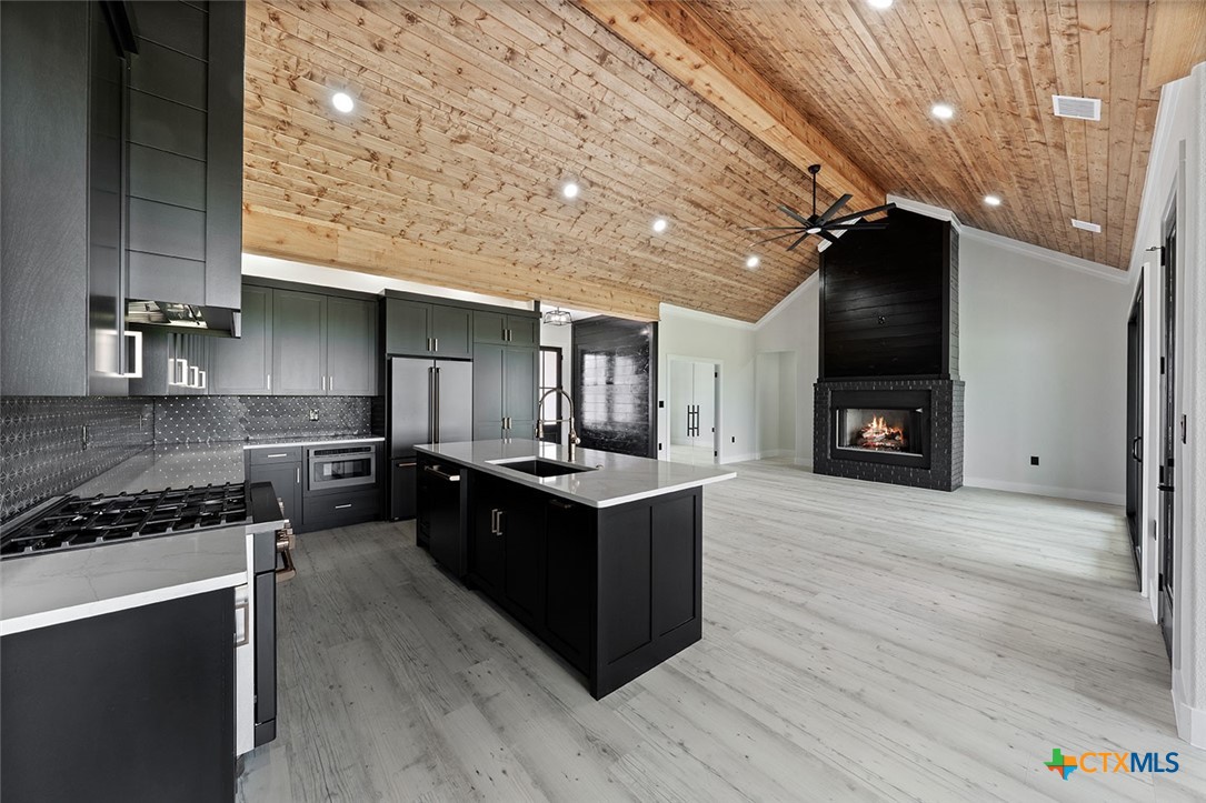 1220 Hadley Lane Copperas Cove, TX 76522 - Photo 3 of 17 a kitchen with wooden cabinets and a stove top oven