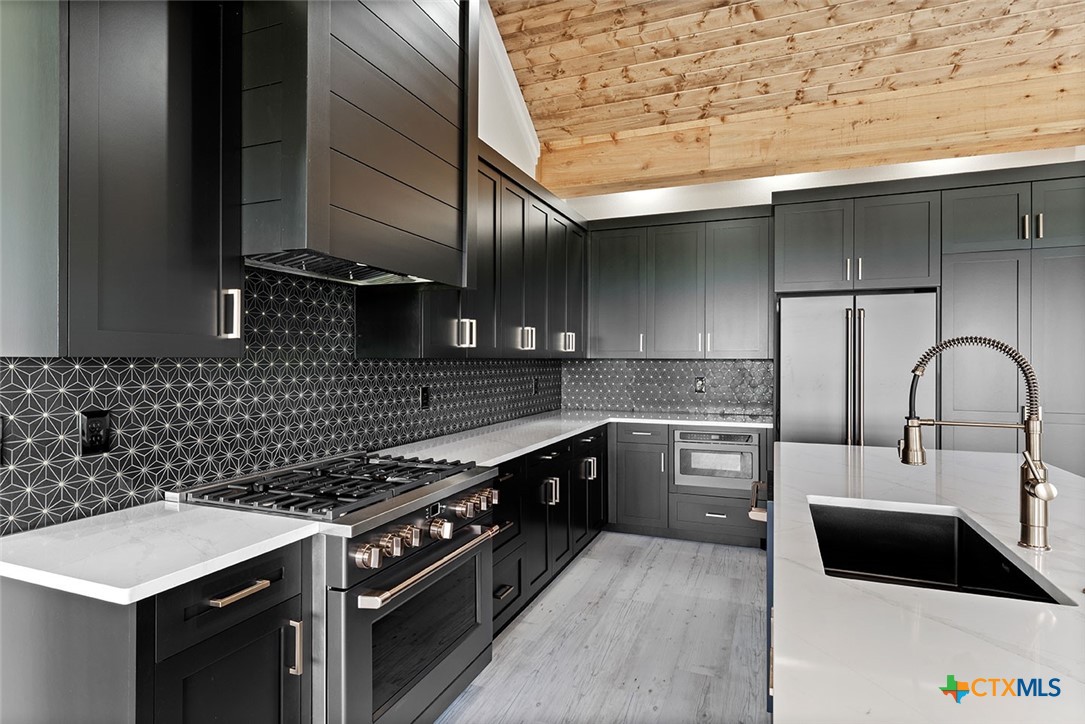 1220 Hadley Lane Copperas Cove, TX 76522 - Photo 4 of 17 a kitchen with a stove a sink and a refrigerator