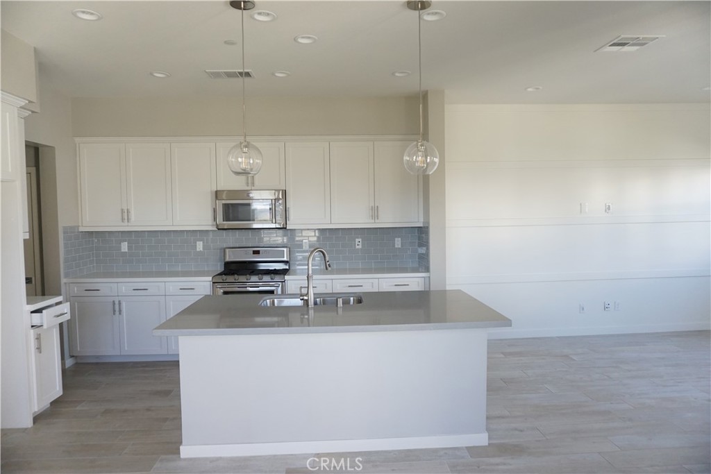 163 Patria Rancho Mission Viejo, CA 92694 - Photo 6 of 25 a kitchen with cabinets appliances a sink and a counter top space