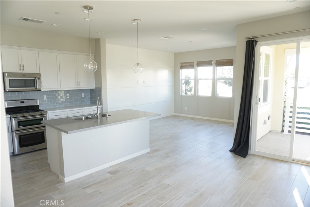 163 Patria Rancho Mission Viejo, CA 92694 - Photo 7 of 25 a large kitchen with a stove a sink and a refrigerator