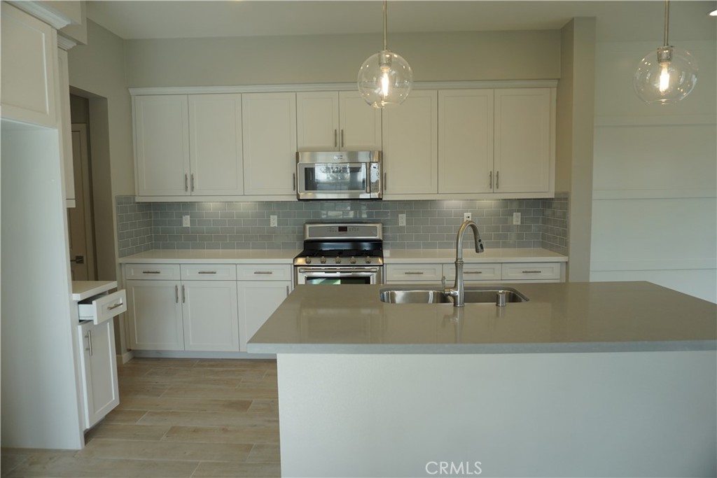163 Patria Rancho Mission Viejo, CA 92694 - Photo 8 of 25 a kitchen with stainless steel appliances granite countertop a sink and cabinets