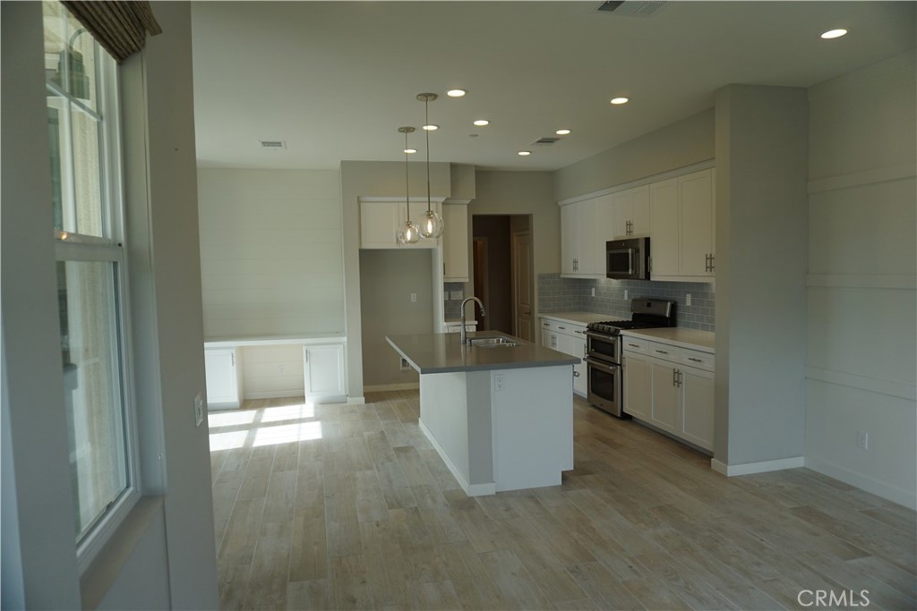 163 Patria Rancho Mission Viejo, CA 92694 - Photo 9 of 25 a kitchen with white cabinets and refrigerator