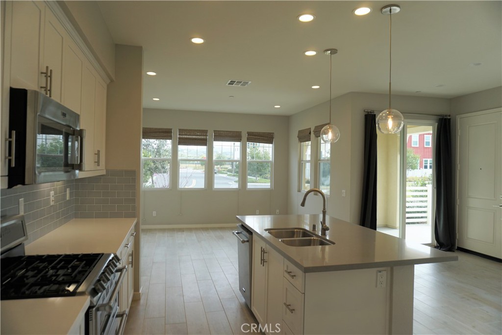 163 Patria Rancho Mission Viejo, CA 92694 - Photo 10 of 25 a kitchen with stainless steel appliances granite countertop a sink stove and cabinets