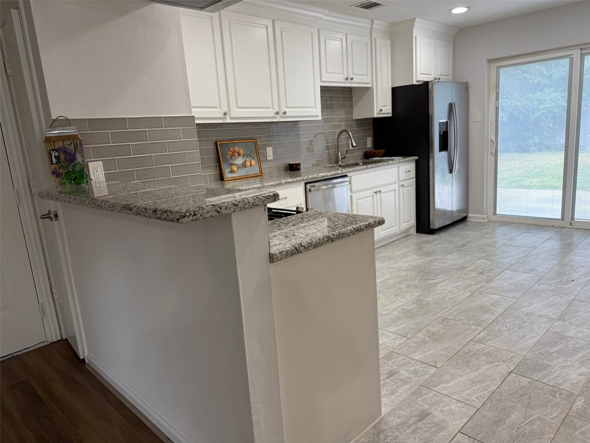 9626 Magnolia Ridge Drive Houston, TX 77070 - Photo 11 of 40 a kitchen with stainless steel appliances granite countertop a refrigerator sink and microwave