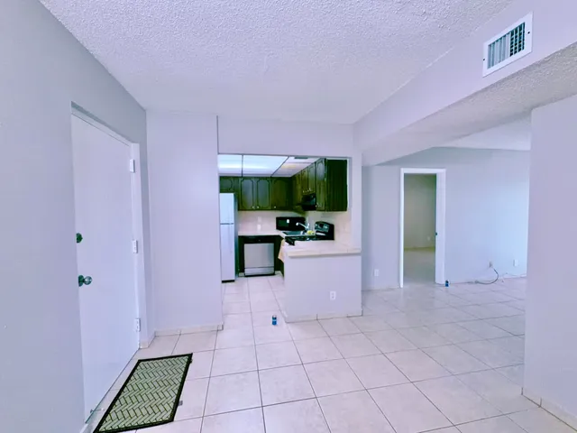 a view of kitchen with furniture flat screen tv and garden view
