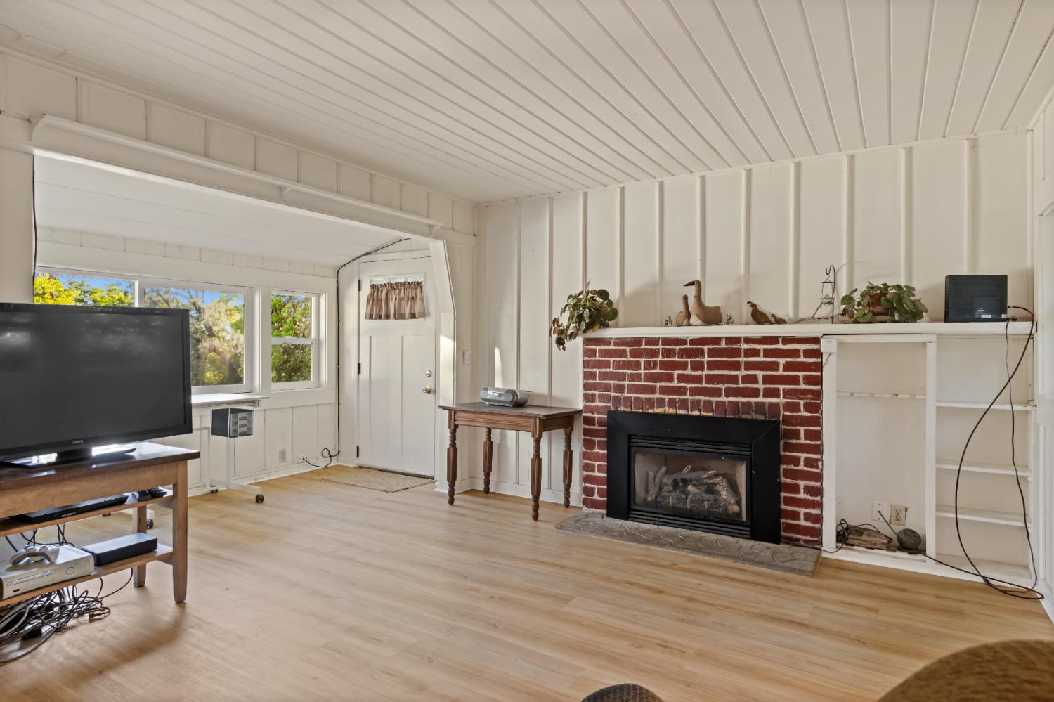 6641 Ribbon Lane Placerville, CA 95667 - Photo 3 of 21 a living room with furniture a fireplace and a flat screen tv