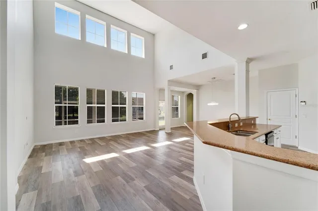 an aerial view of residential houses with outdoor space and trees